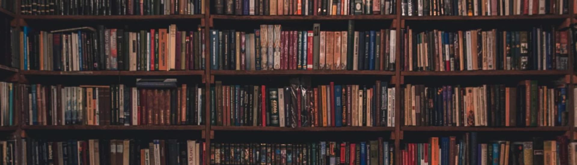 A wooden bookshelf filled with various books.